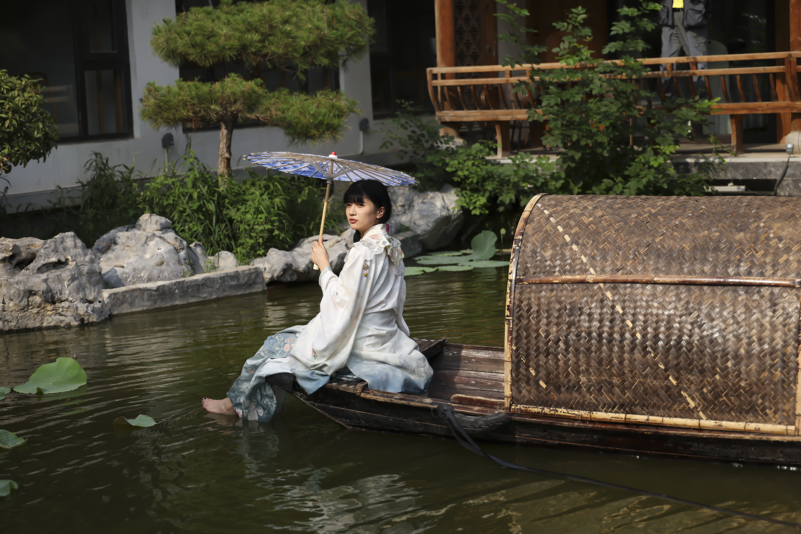 园林水榭旁，舟上汉服彰